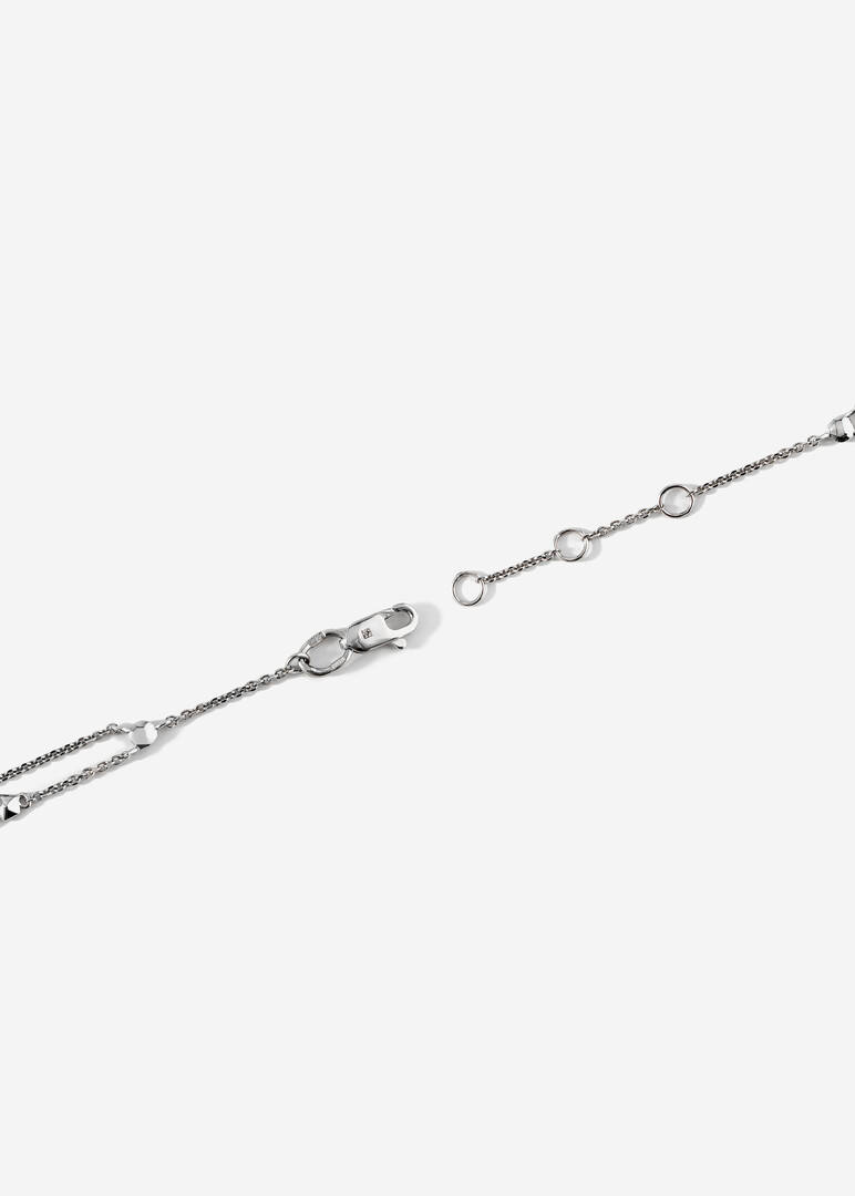 A thin gold chain bracelet with black diamonds