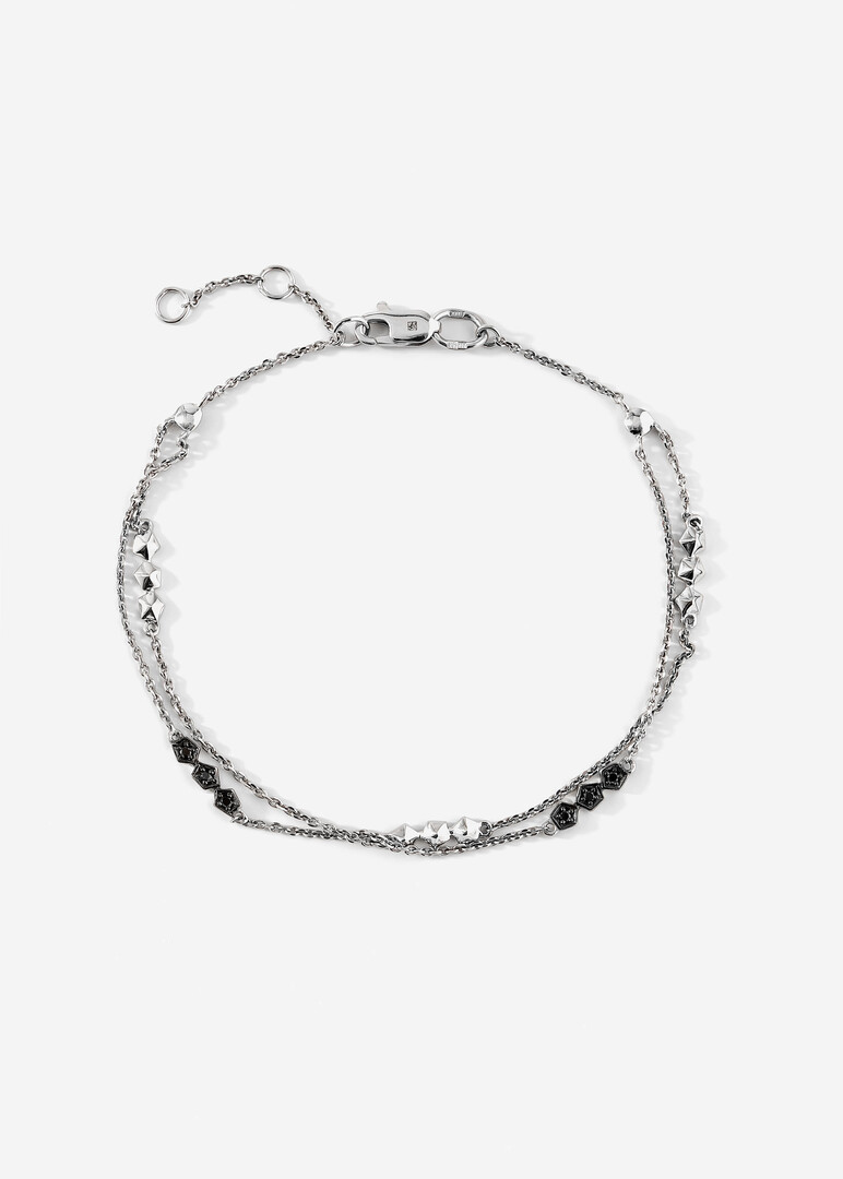 A thin gold chain bracelet with black diamonds