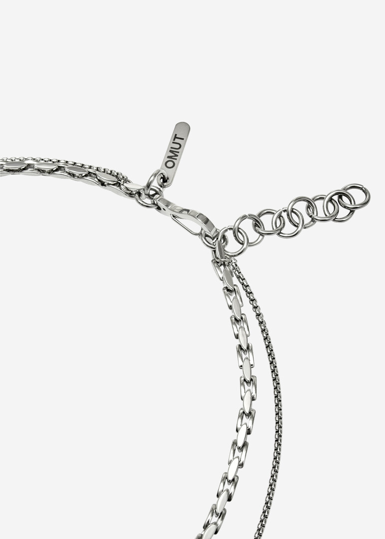 A necklace of two types of chains with a pendant in the form of a card suit CLUB clubs made of steel and bronze with rhodium coating