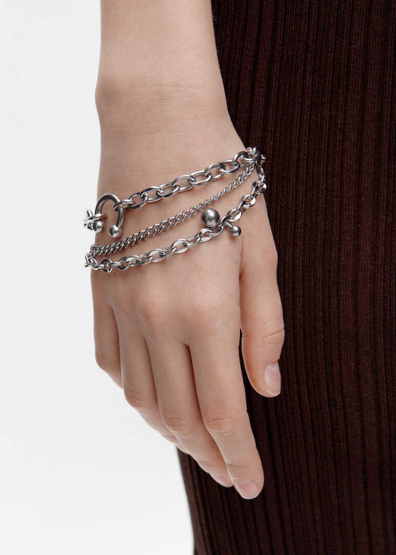 Double bracelet made of multi-caliber chains and piercing elements of DARE made of steel