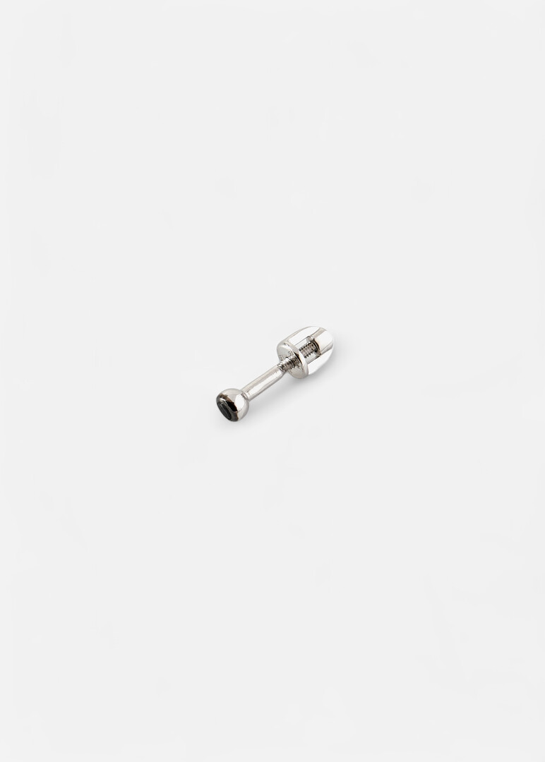 Piercing made of gold with a black diamond