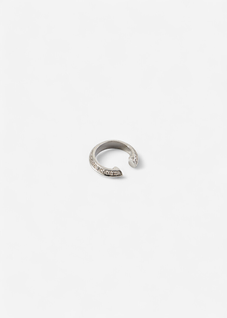 The cuff made of silver with cubic zirconia "Saturn" is narrow in the middle