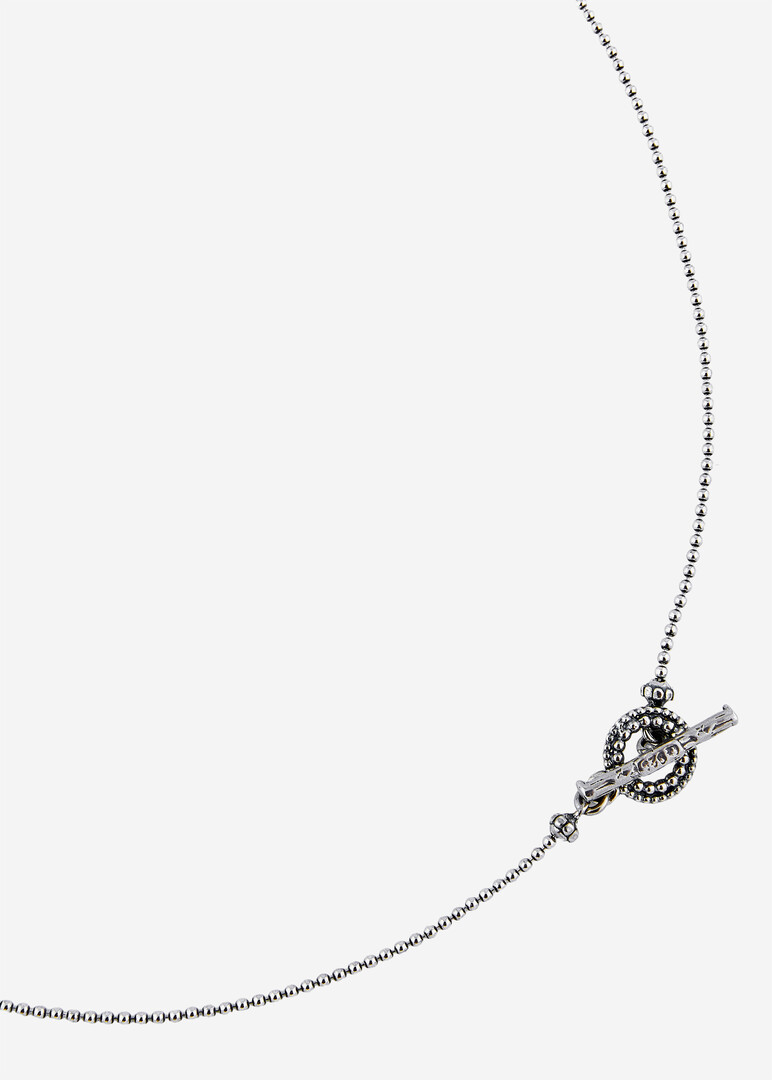 silver chain necklace with a green eye pendant