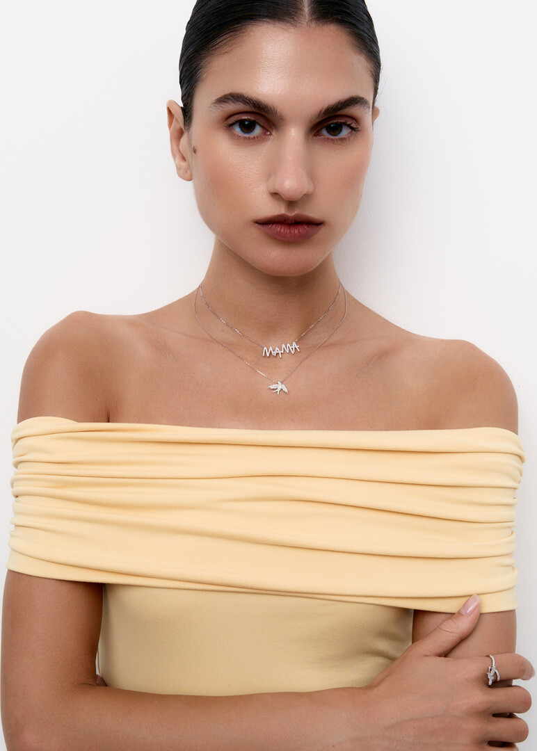 gold necklace with bird pendant and diamonds