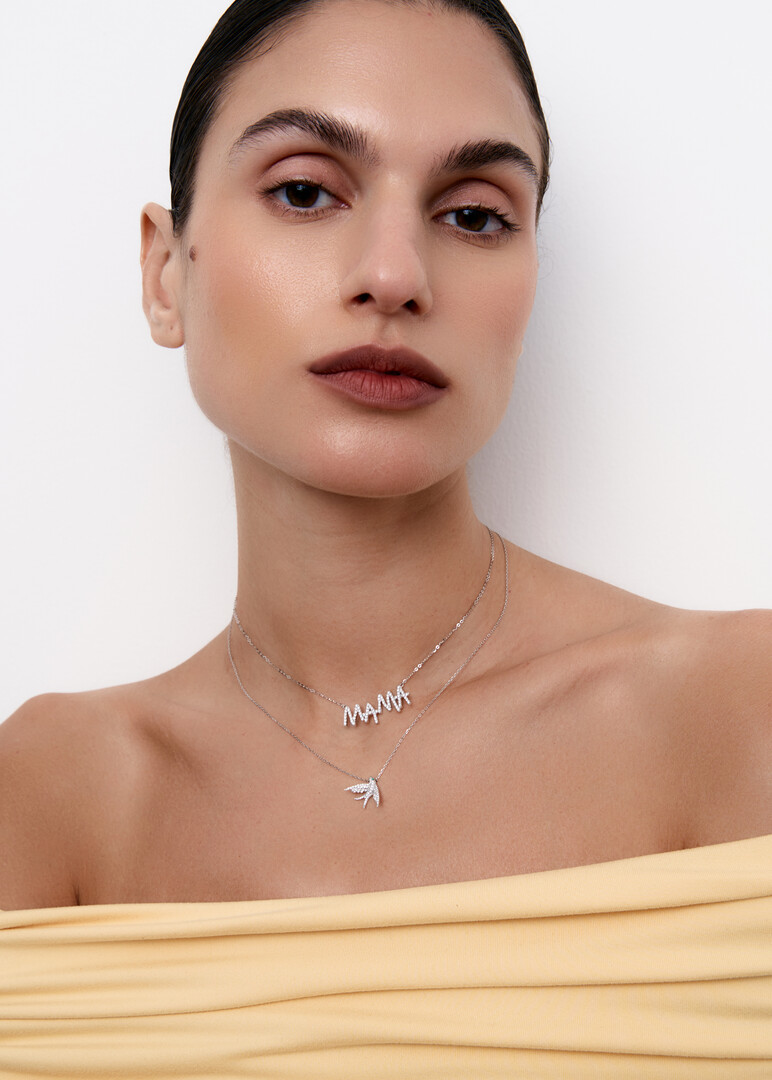 gold necklace with bird pendant and diamonds