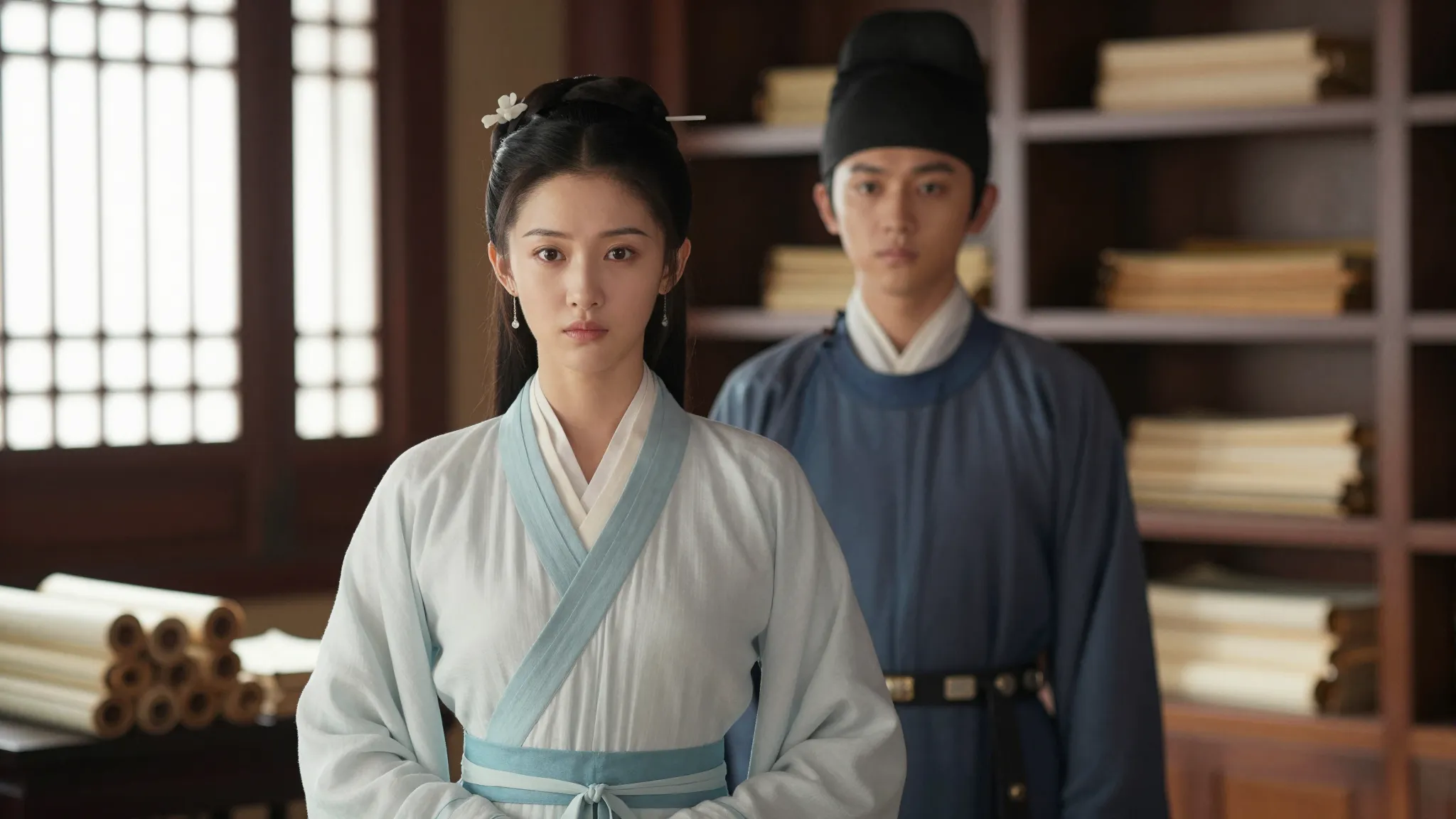 A young Chinese woman in a simple scholar's robe and her bro...