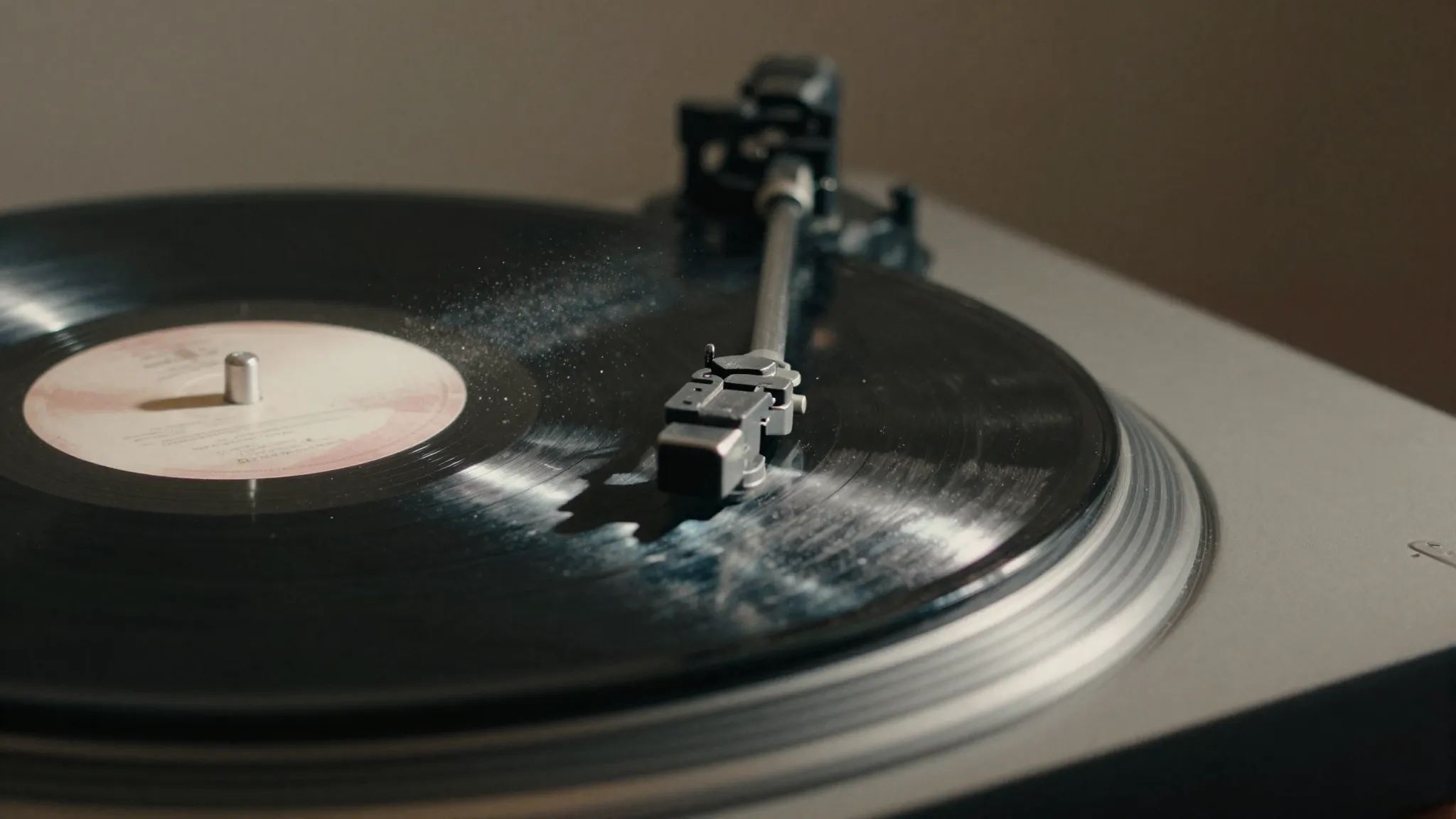 A vintage vinyl record spinning on a turntable, close up sho...