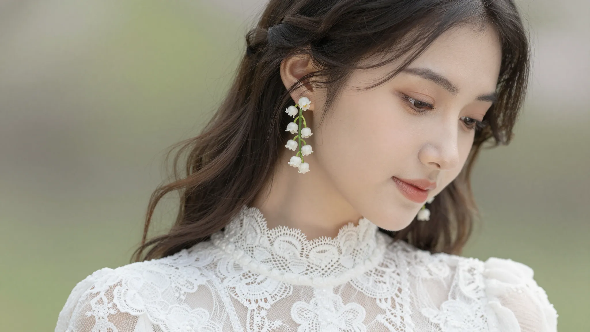 A beautiful young woman in a white lace dress wearing elegan...