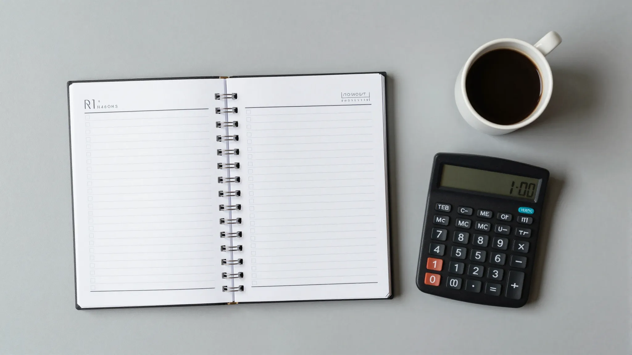 A minimalist workspace with a planner, a calculator, and a c...