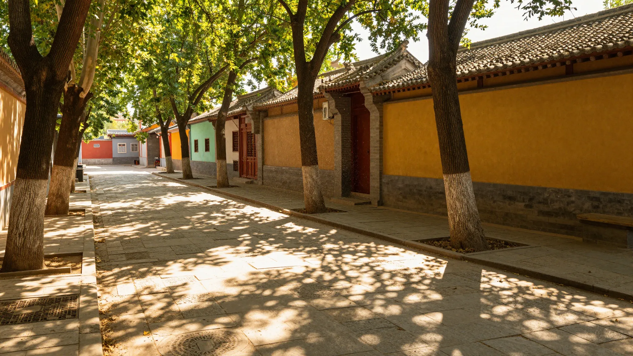 A sunlit summer alley with old stone tiles and dancing shado...