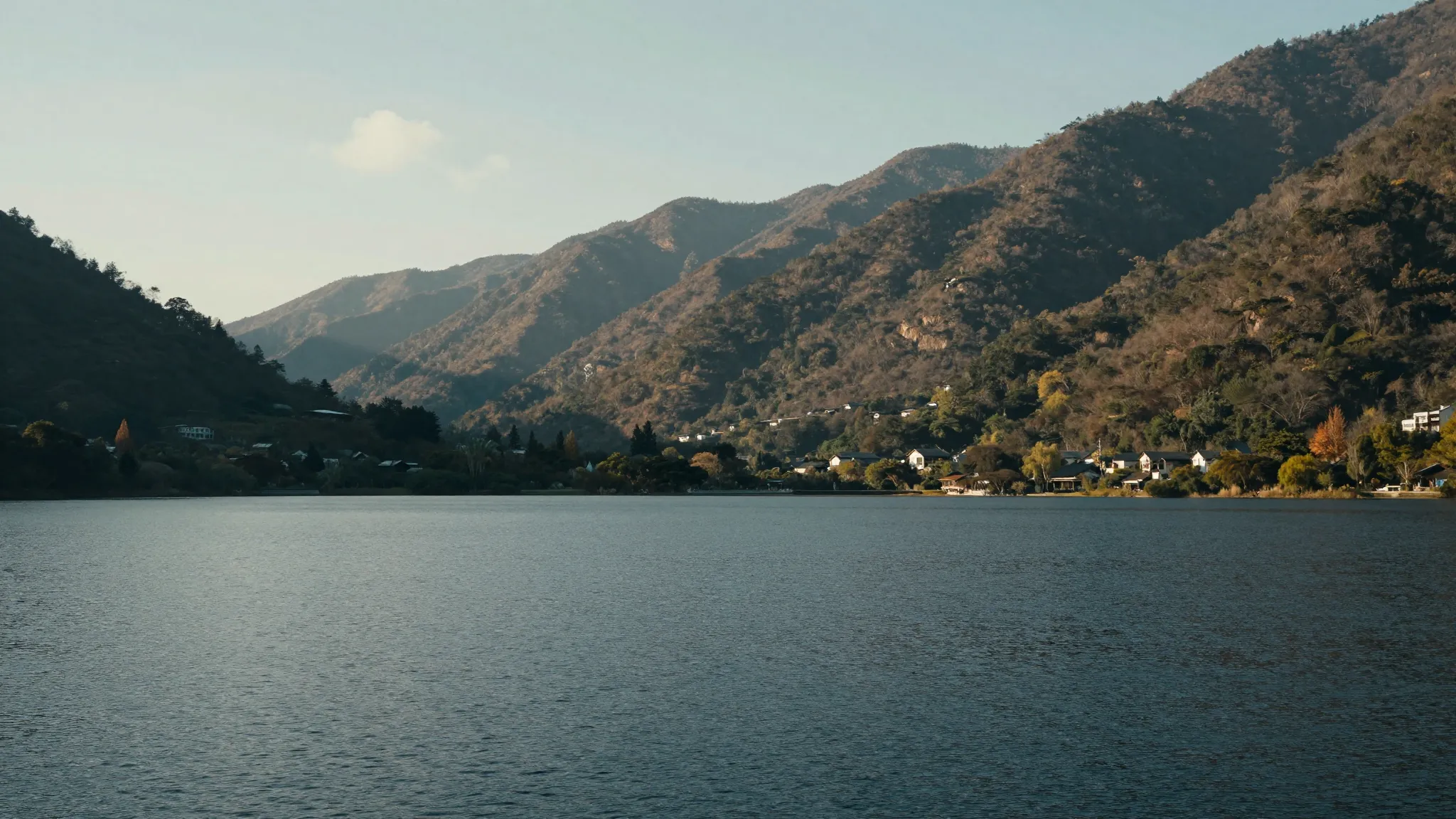 A peaceful landscape with a calm lake and mountains, symboli...