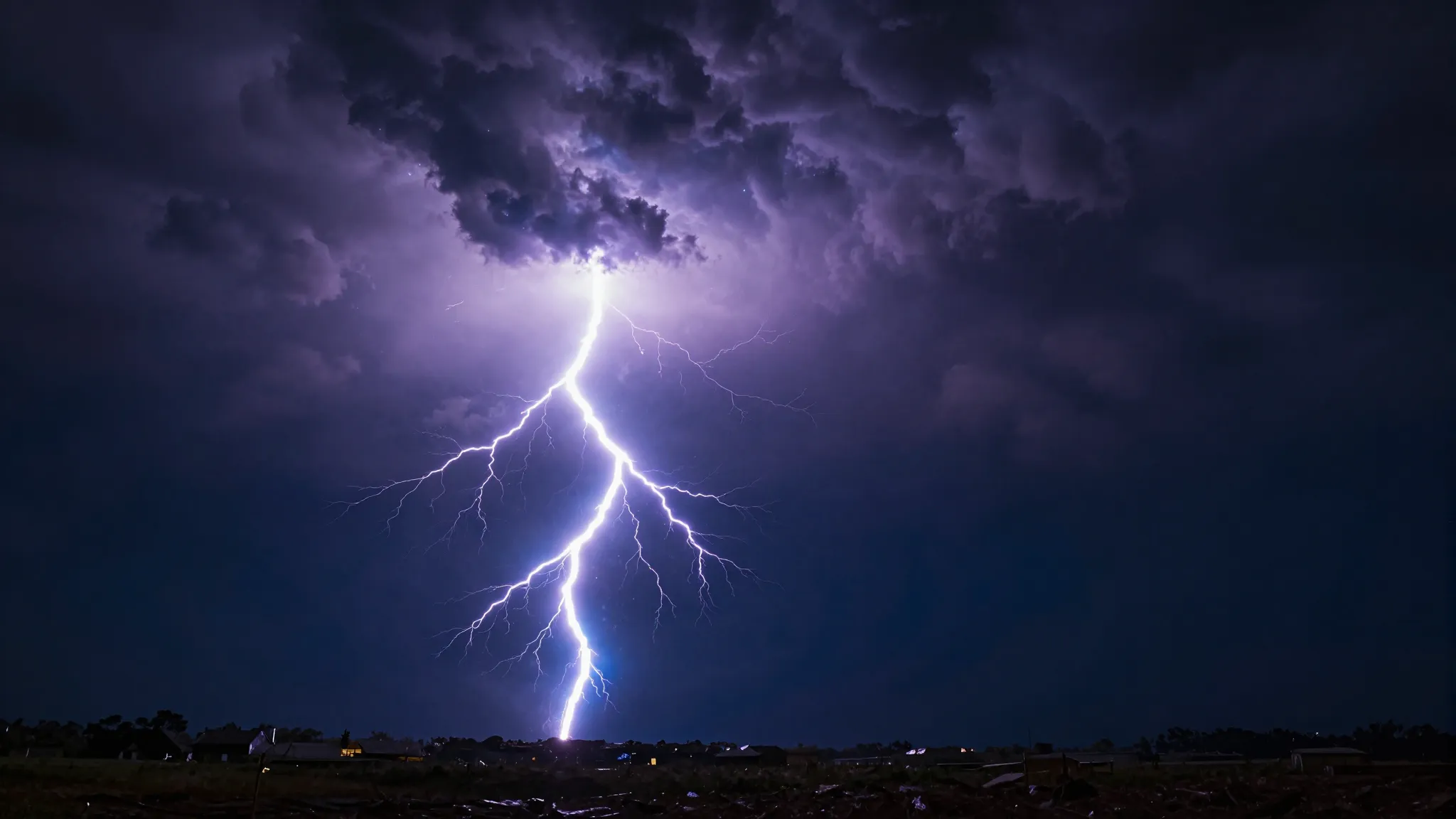 Powerful forked lightning bolt striking from dark dramatic s...