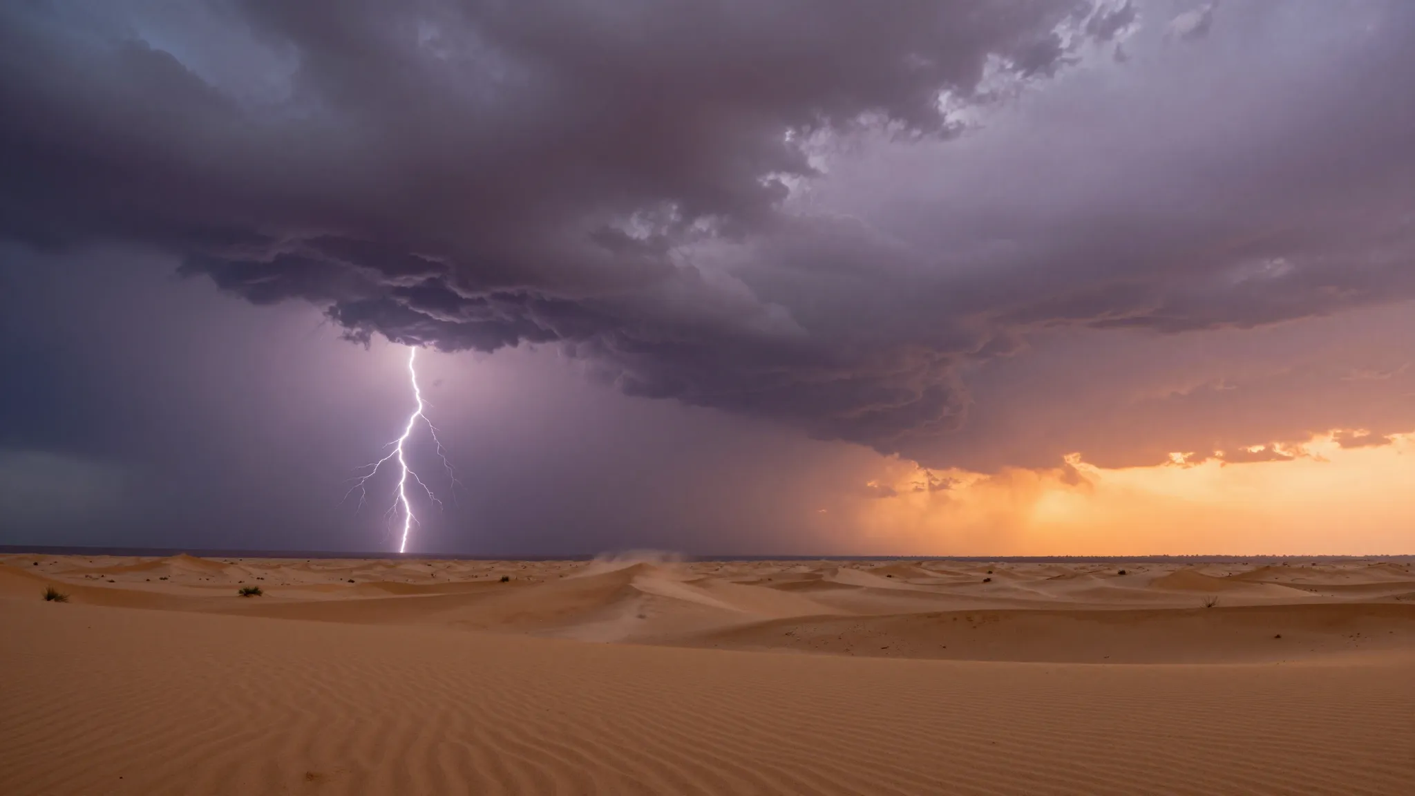Summer desert storm at sunset. Dark purple and grey clouds c...