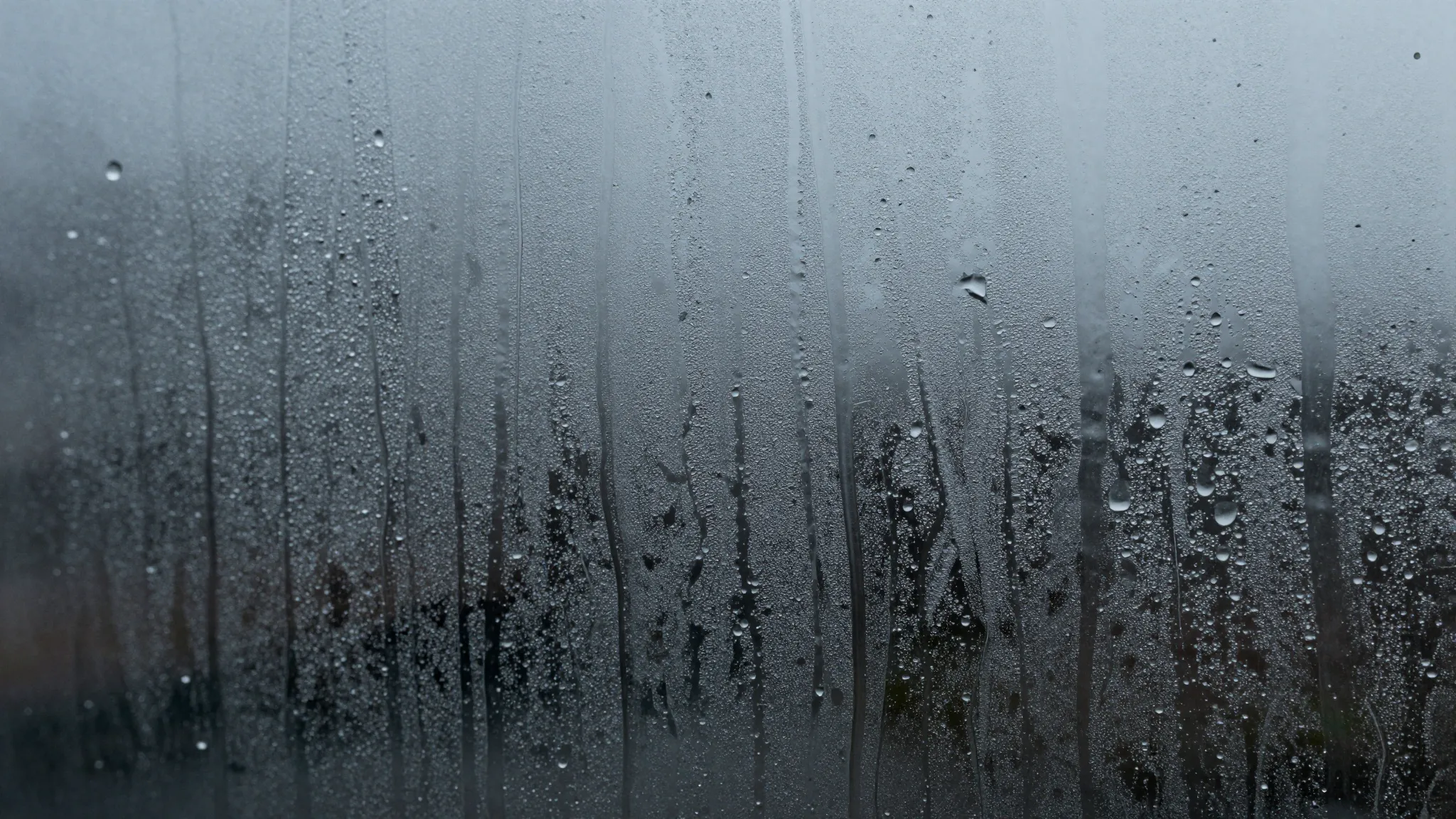 Heavy rain and melting slush on glass, emphasis on long liqu...
