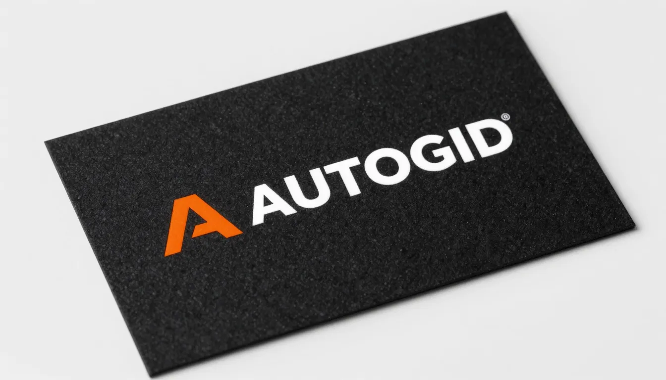 Close-up of a premium business card for 'AUTOGID'. Black tex...