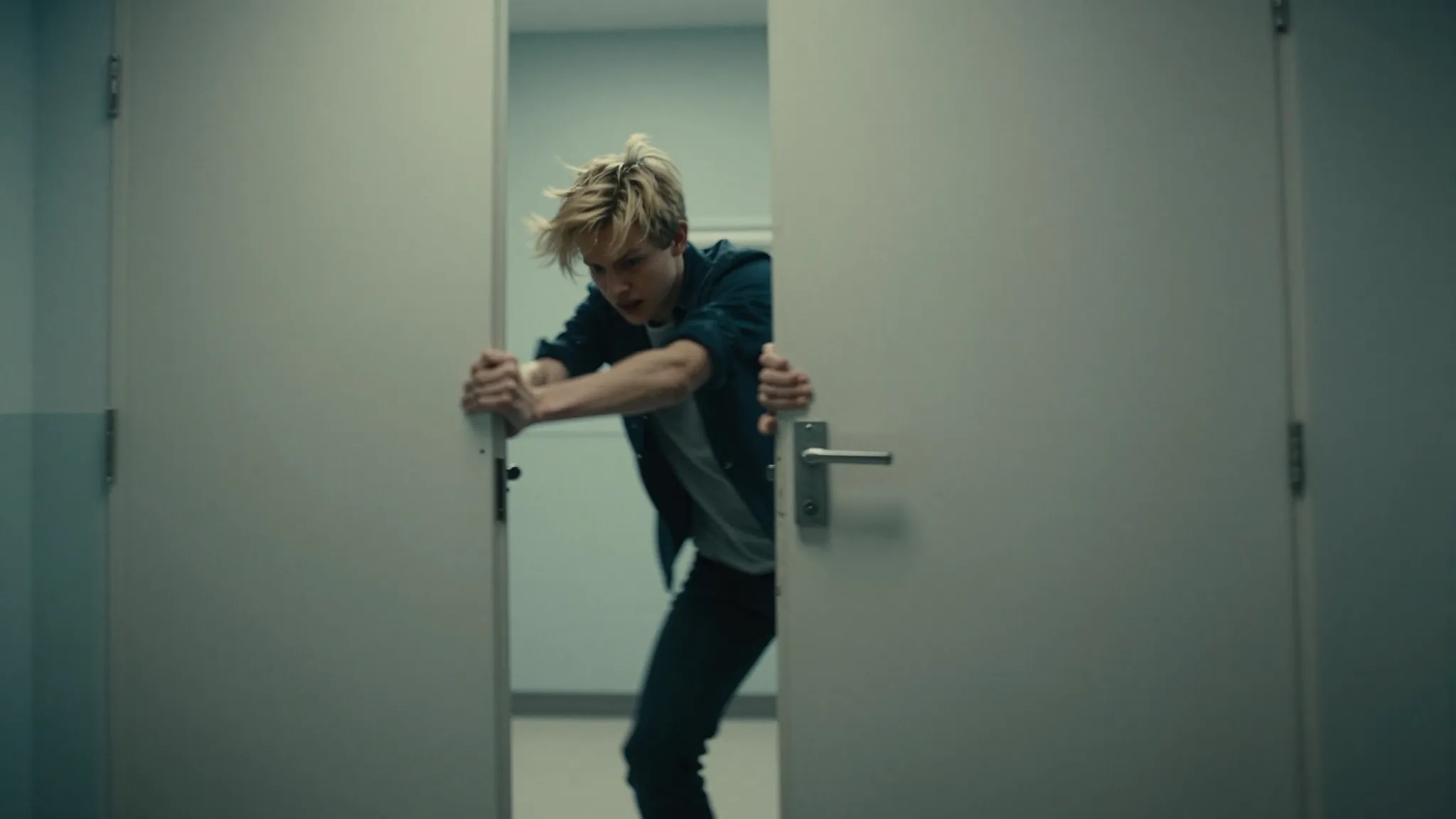 A dramatic scene of a teenager with golden hair breaking fre...