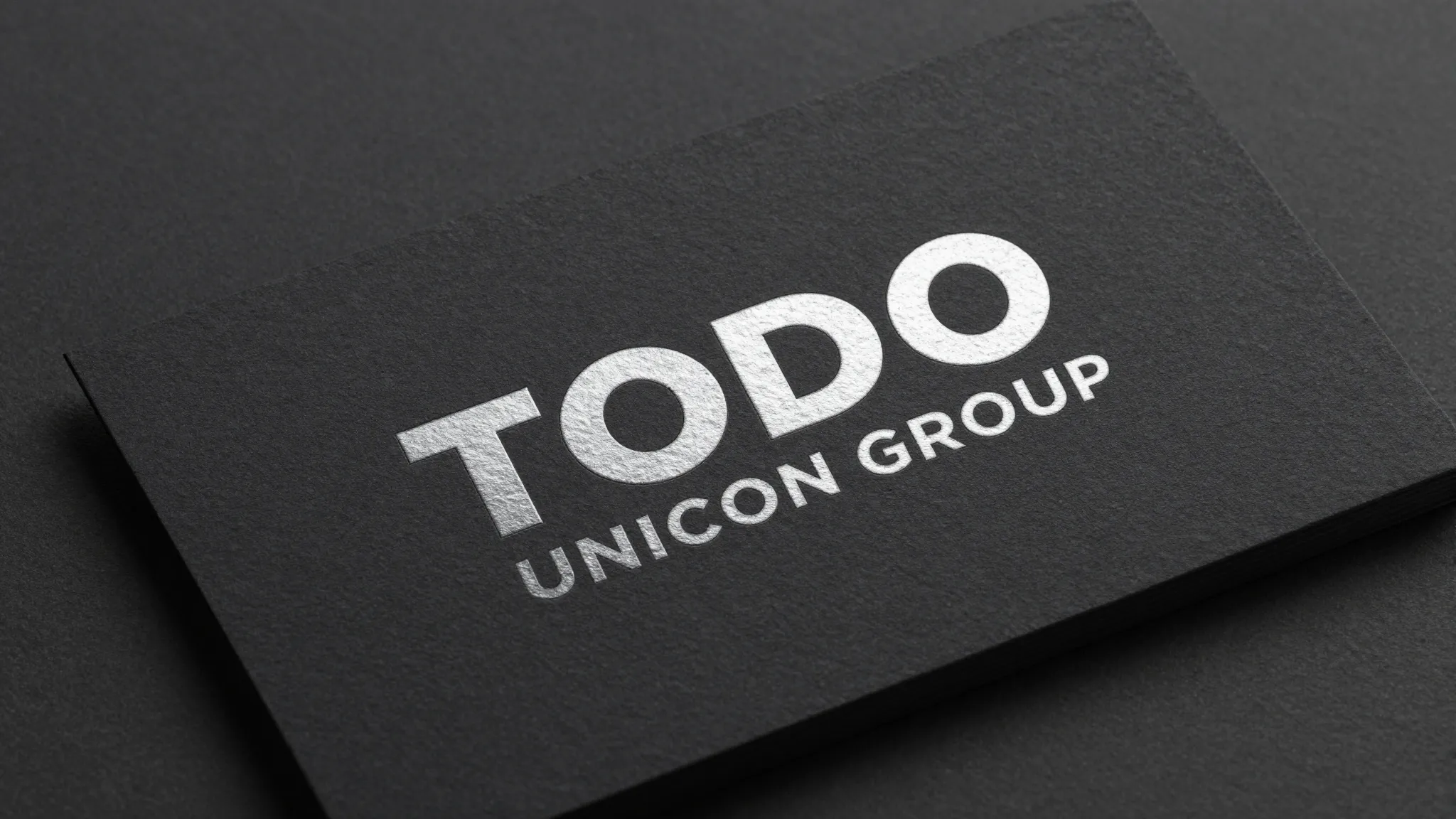 Premium business card mockup for 'TODO UNICON GROUP', dark m...