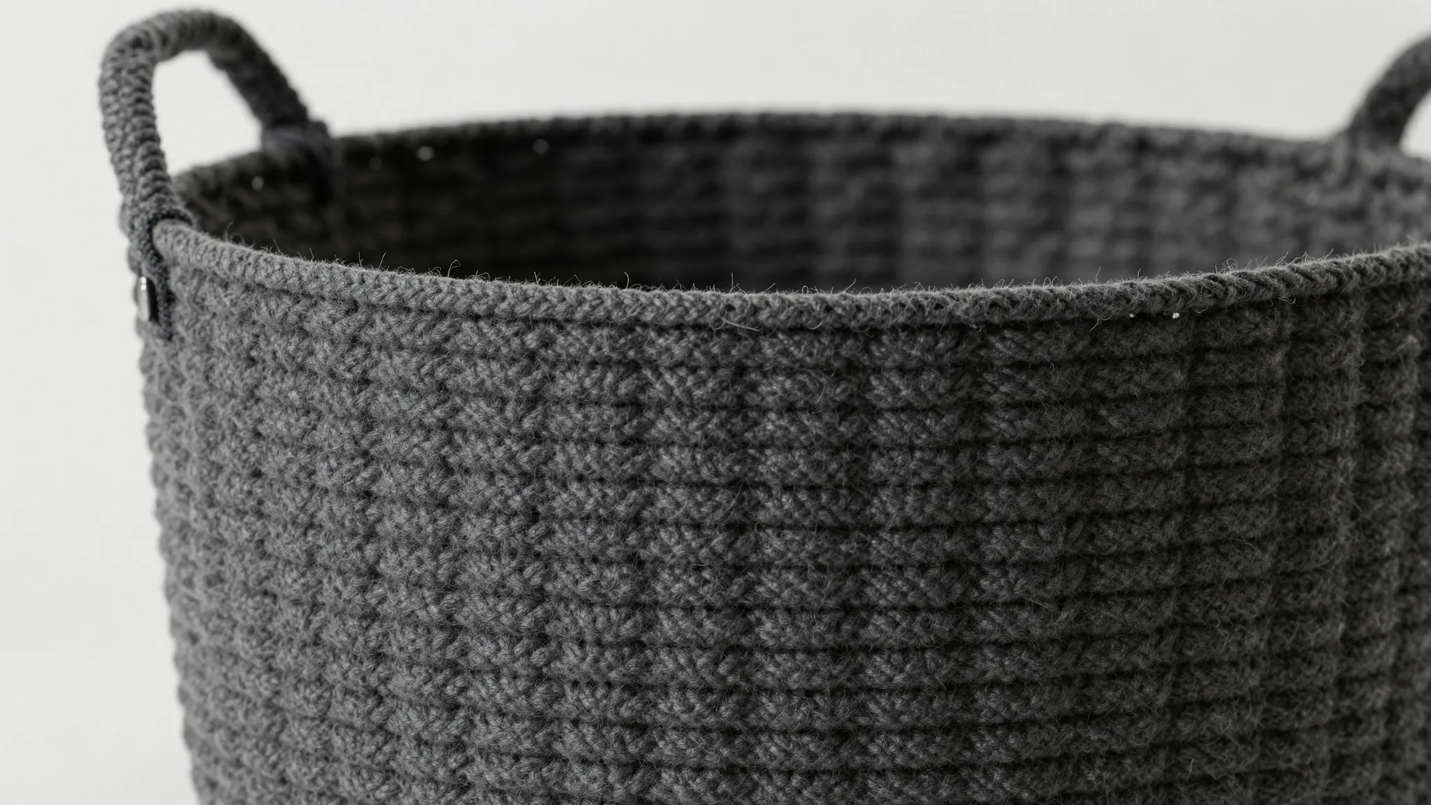 Close-up of a dark grey textured handmade basket, premium po...