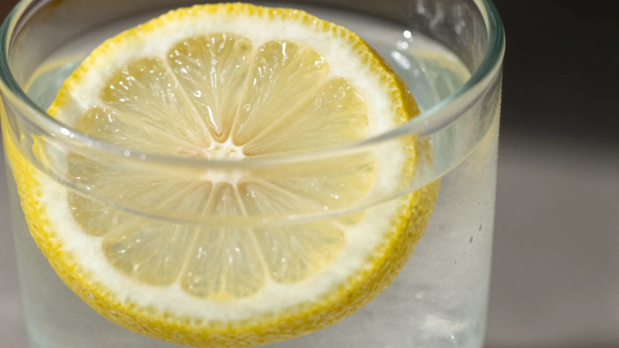 Close up of a glass of pure water with a lemon slice, bright...