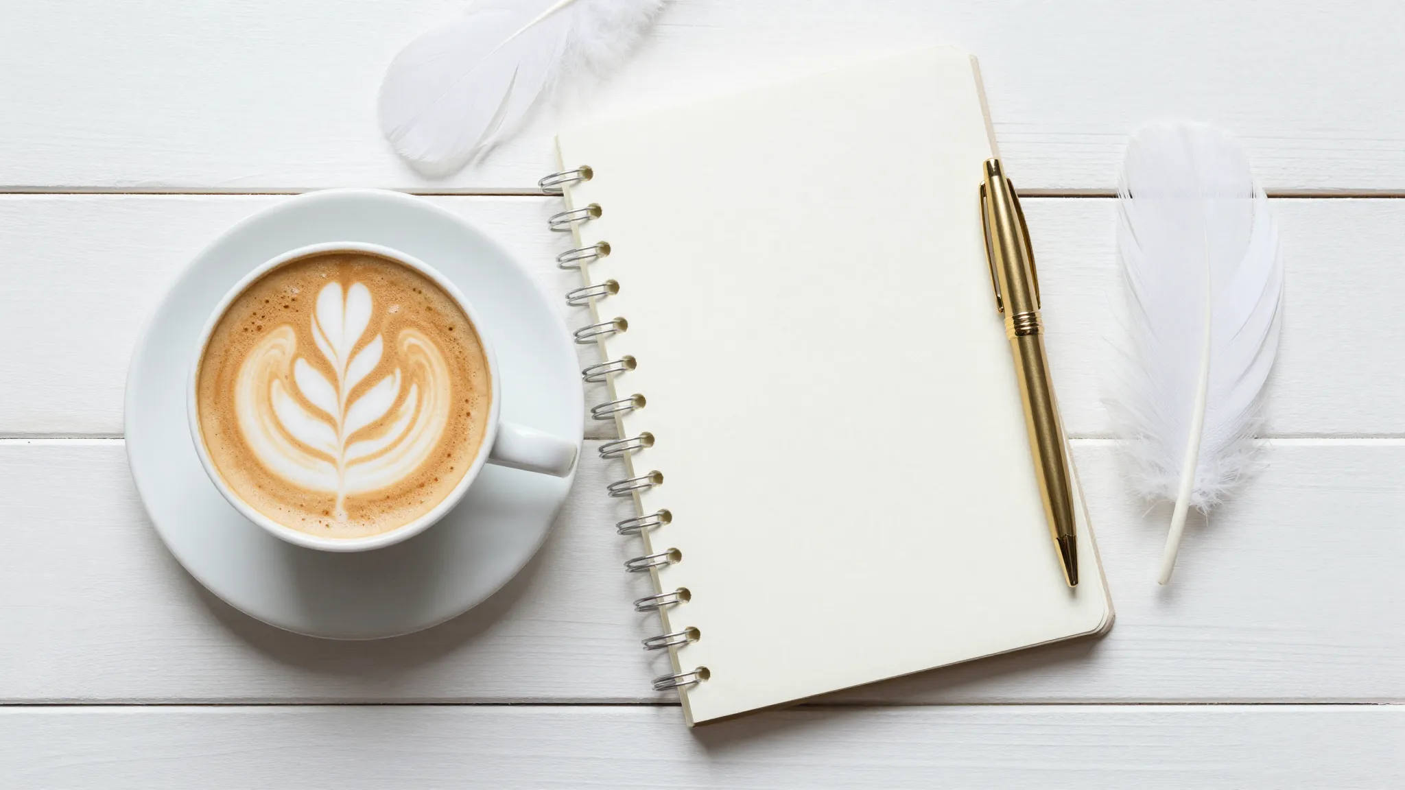 Flat lay composition on a white wooden table, a cup of cappu...