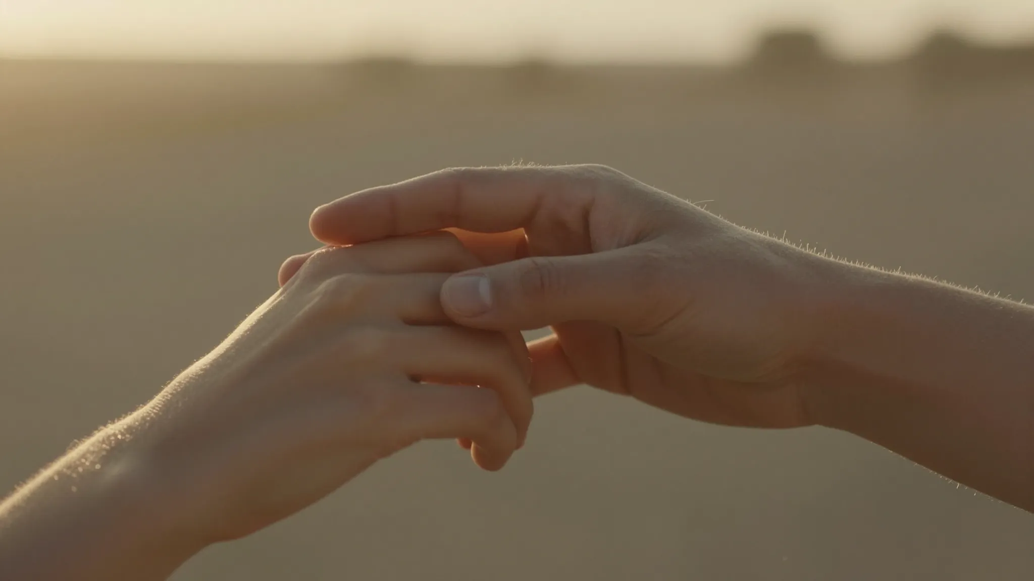 Cinematic close-up of a couple's hands gently touching, warm...
