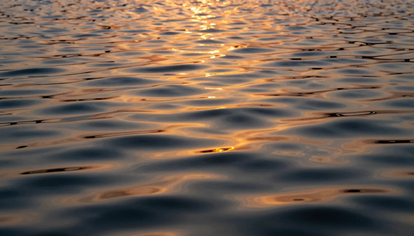Artistic close-up of water ripples on a lake reflecting a su...