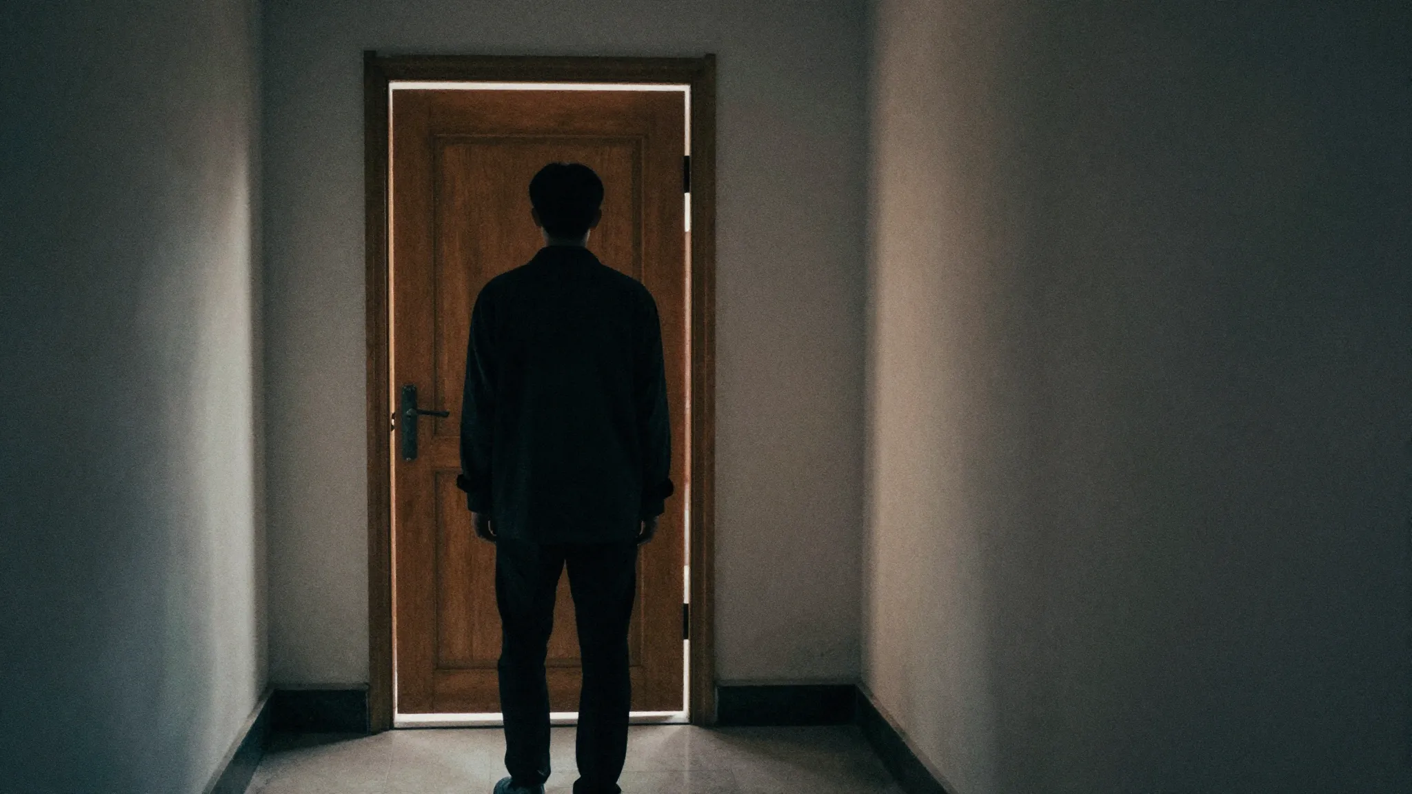 Watercolor style. A dark silhouette of a person standing in ...