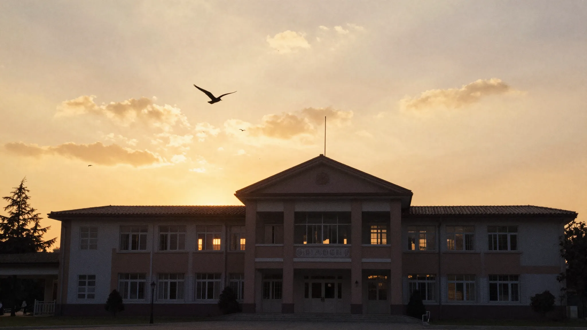 Watercolor style. Silhouette of a school building at sunset,...