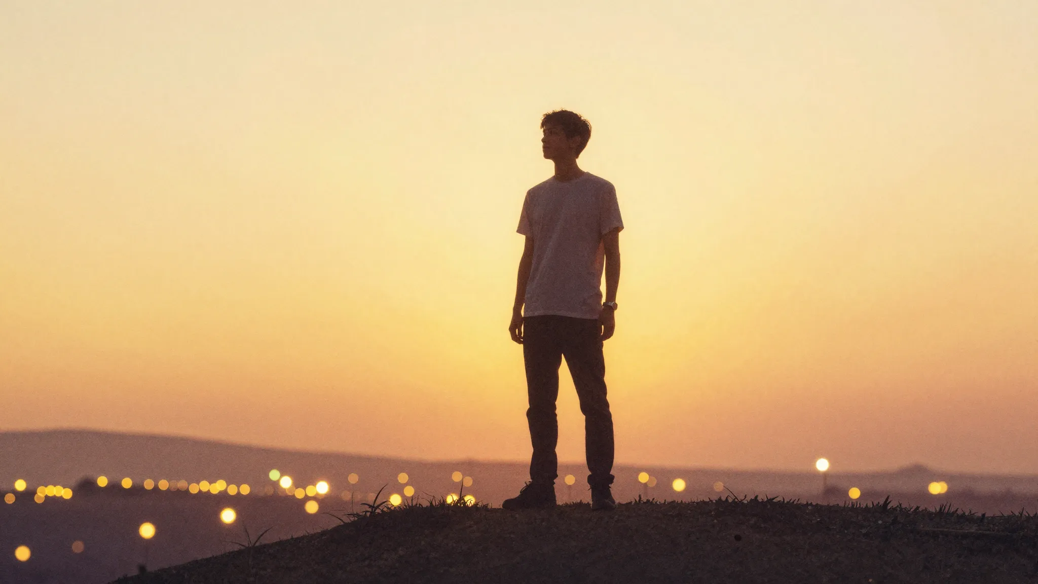 Watercolor style. A bright silhouette of a young man standin...