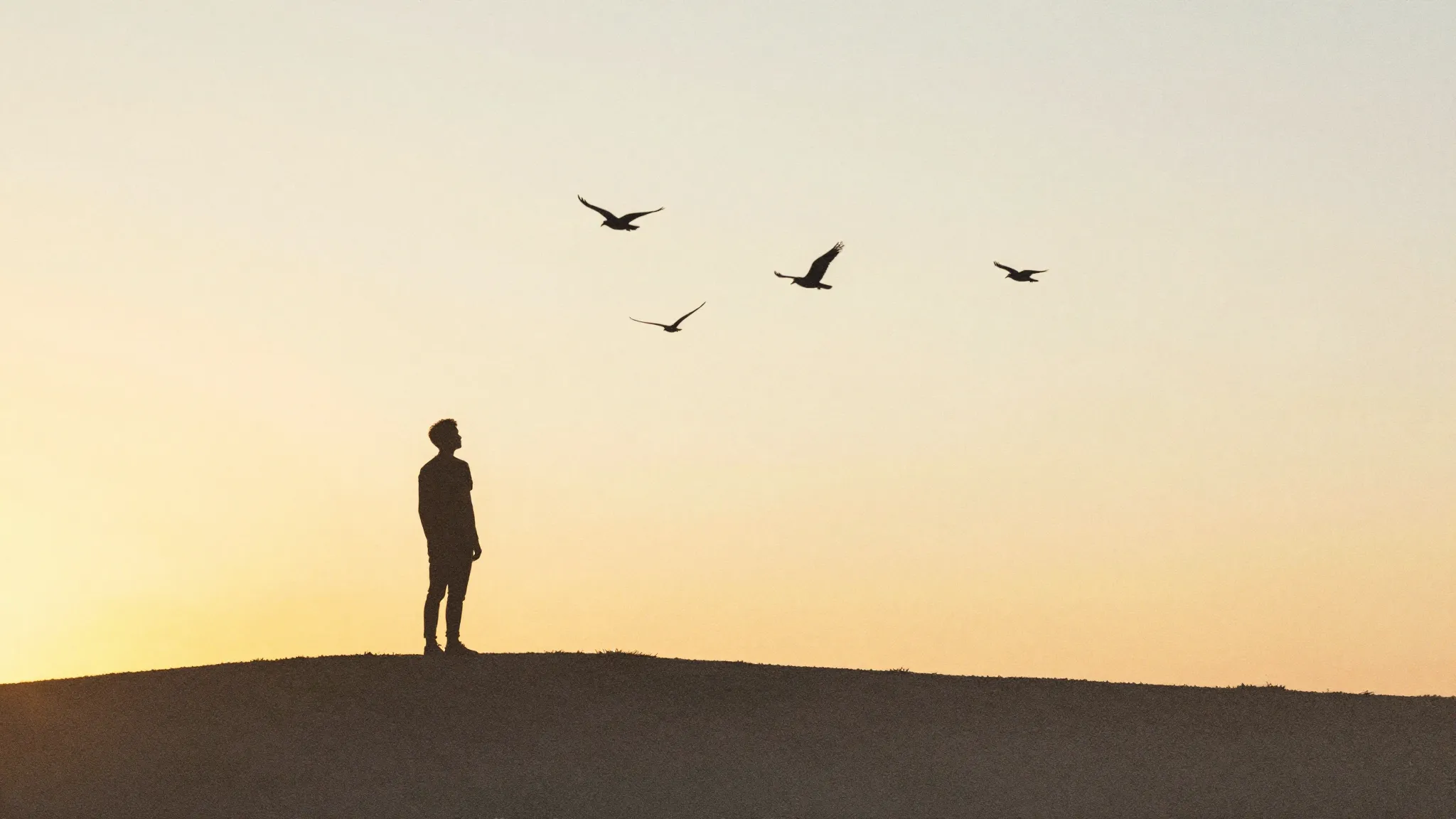Watercolor style. A silhouette of a person standing on a hil...