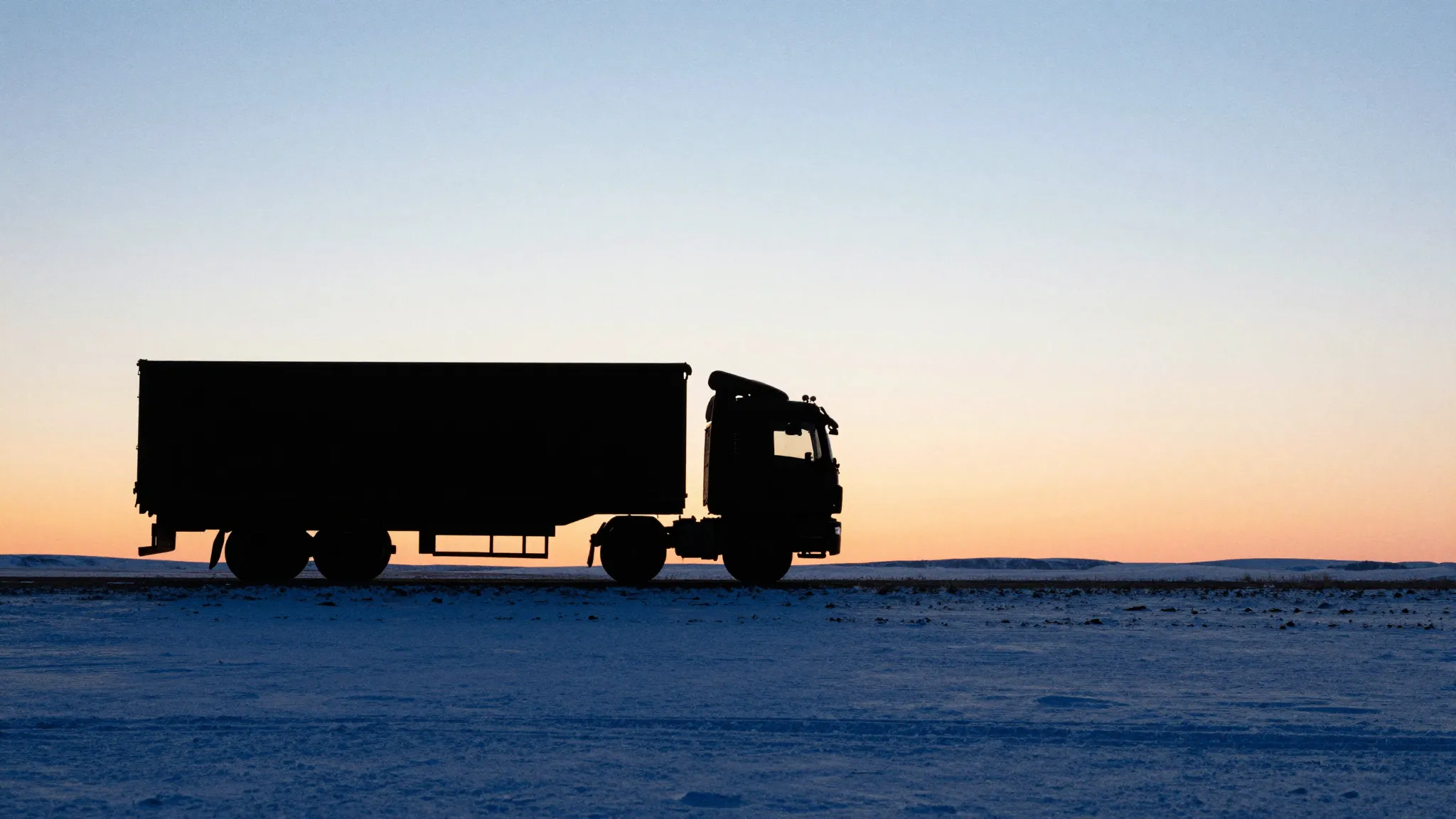 Watercolor style. Silhouette of a large truck on a sunset ho...