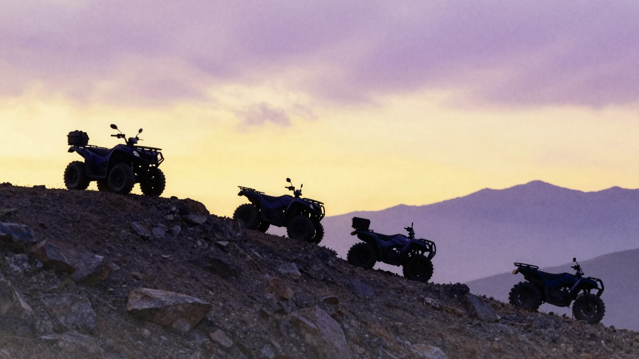 Watercolor style. Silhouettes of several ATVs on a high moun...