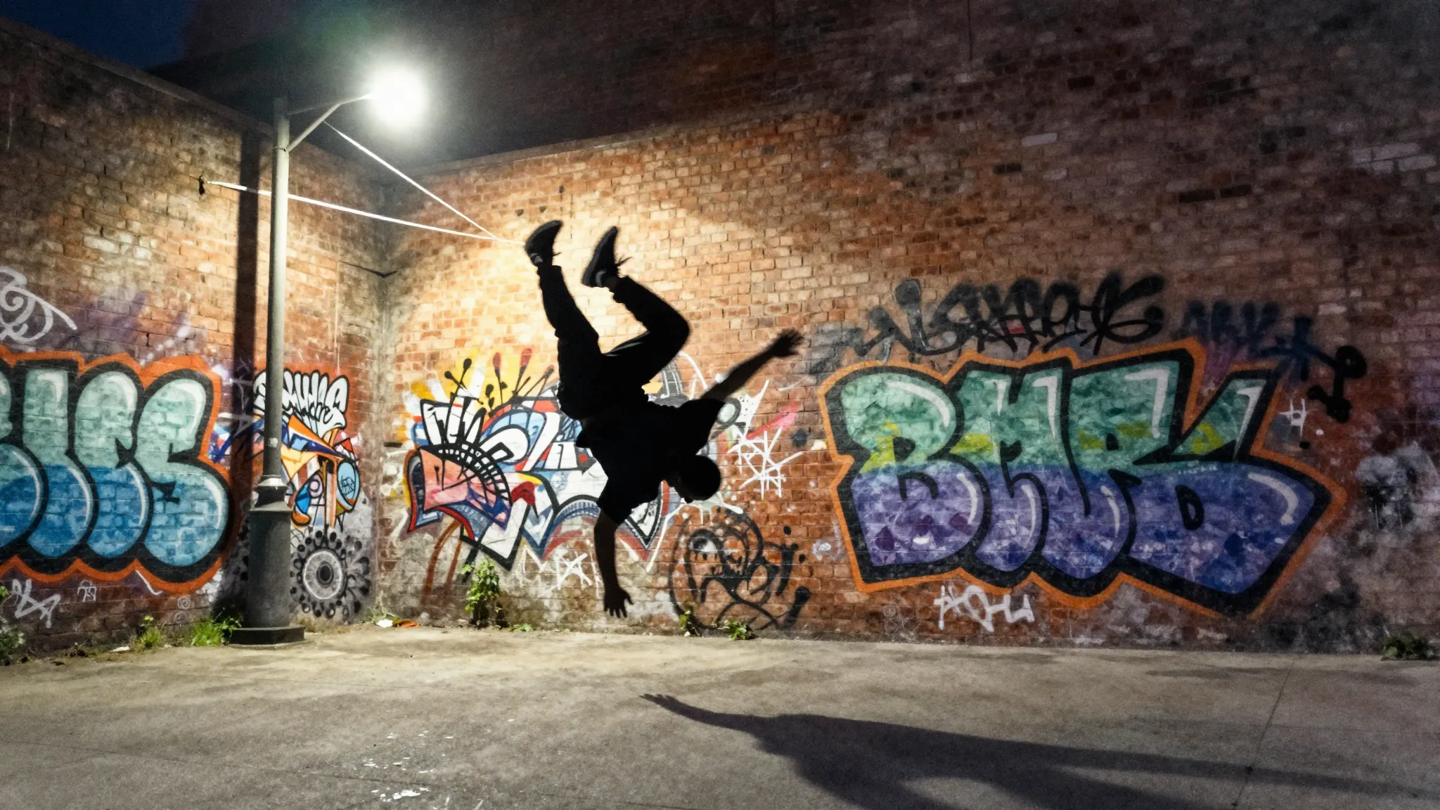 Watercolor style. Silhouette of a b-boy frozen mid-air again...