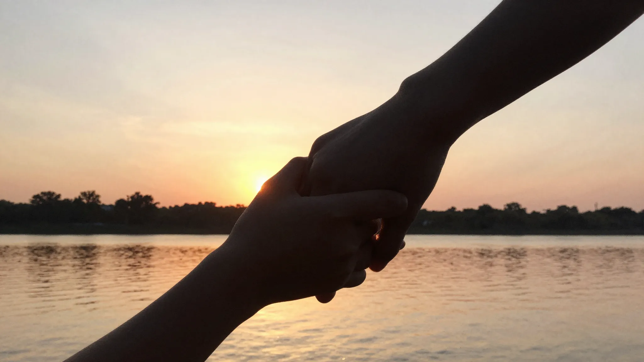 Watercolor style. A silhouette of two hands holding each oth...