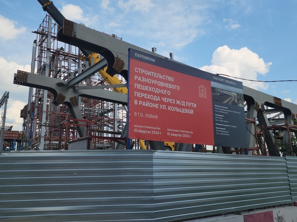 Рабочие устанавливают пролетное строение нового надземного перехода в Лобне