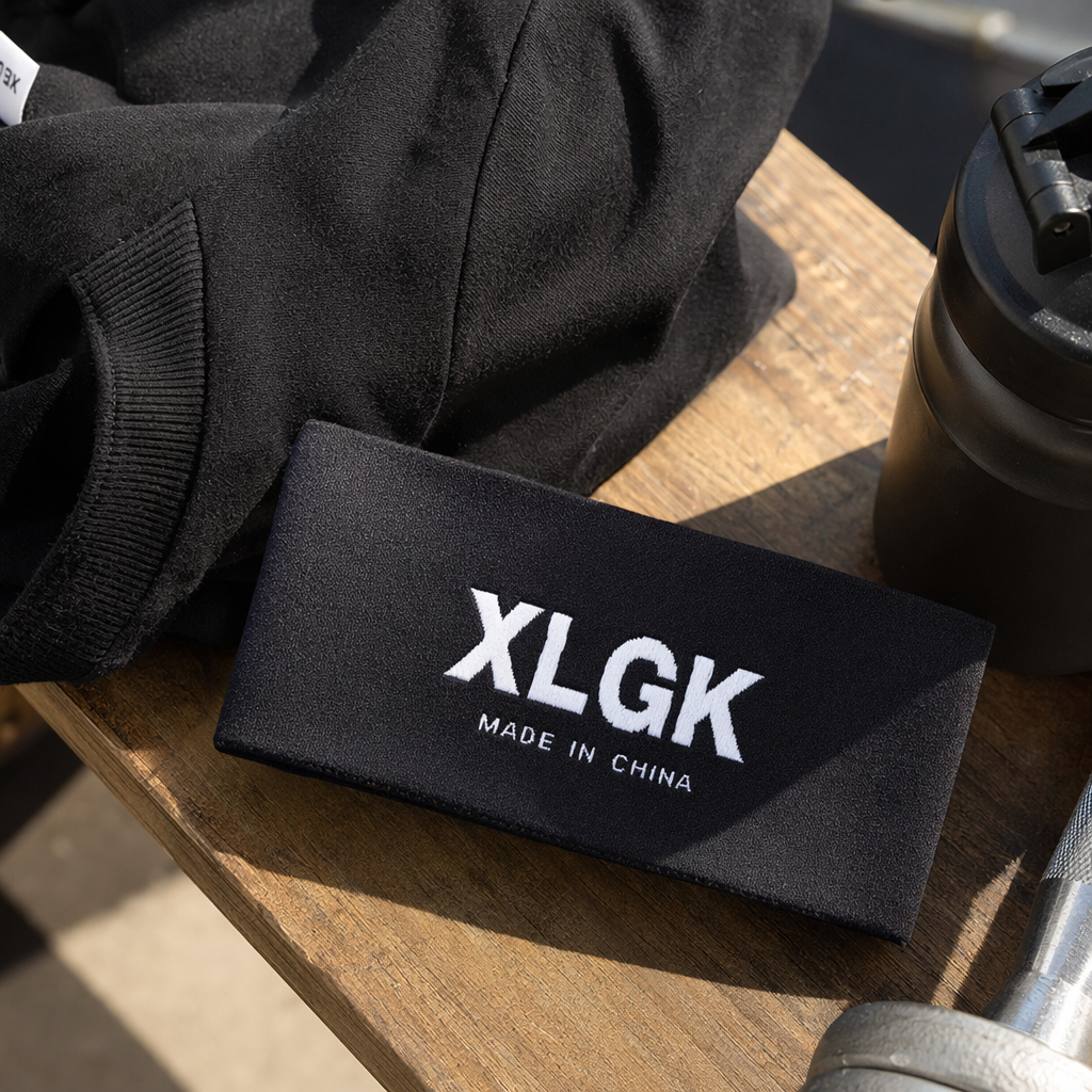 Этикетка тканая чёрная с надписью XLGK оптом из Китая — фотография 3