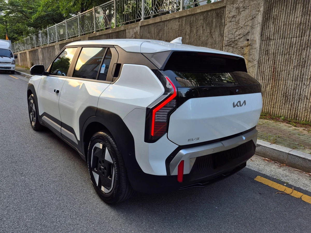Kia EV3 сзади — фирменный шильд KIA на крышке багажника