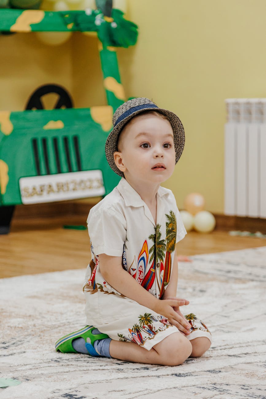 Мальчик 3 лет в шляпе играет