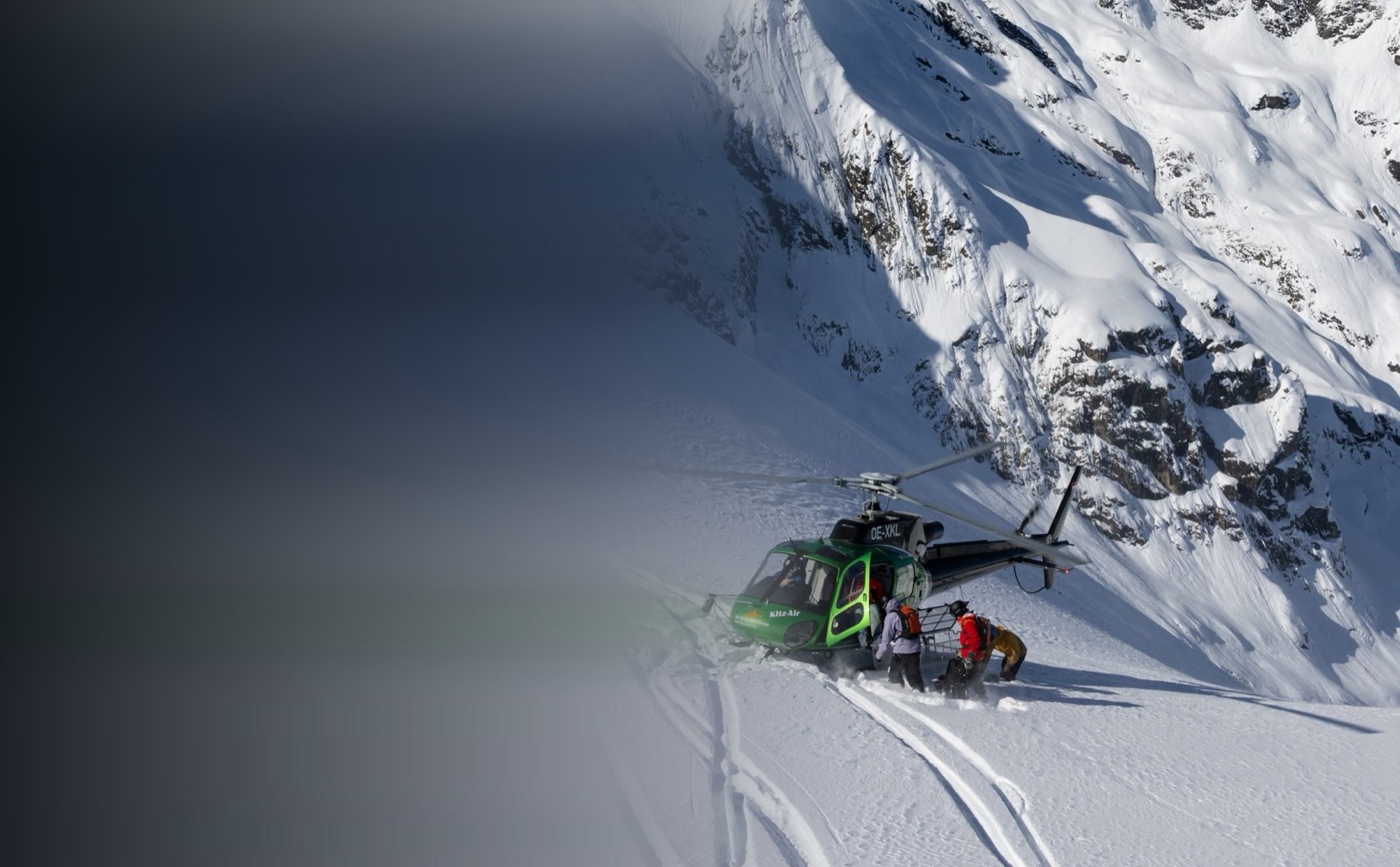 Helicopter on a snowy ridge, heliskiing