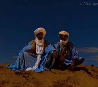 Berbers under the full moon in the desert.